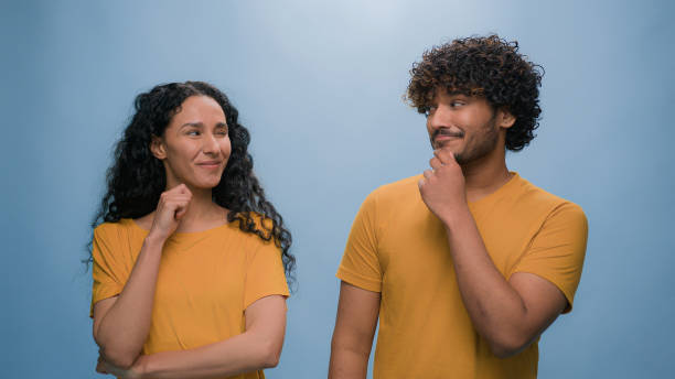 istock Portrait in studio blue background Hispanic boyfriend girlfriend thoughtful think idea problem solution pondering multiracial diverse couple pensive two friends family man woman decision thinking 2187186295