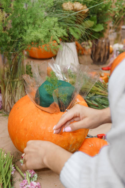 istock Creating a floral composition in a pumpkin. Making decor with your own hands. 2187186317