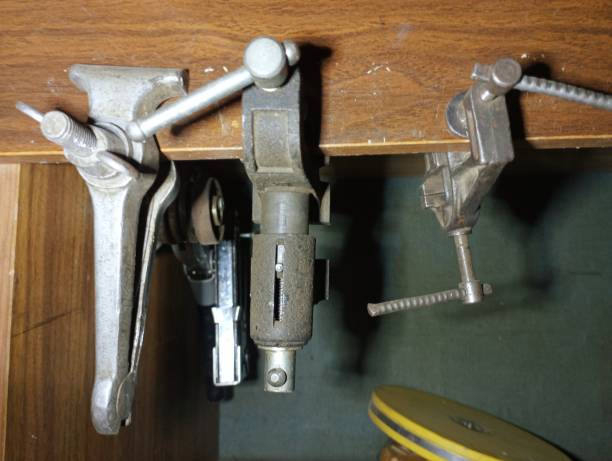 istock Various metal clamps and holders are hanging on a shelf for storing tools. Old tools for work in the garage. 2187187058