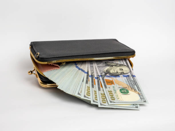 istock bills in wallet. many dollars 2187187452