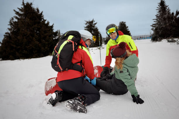 istock Winter rescue service on mountain peak helping young woman 2187187716