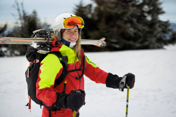 istock Female rescue worker posing for camera while  skiing on the mountain 2187187839