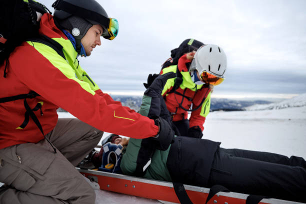 istock Rescue workers assisting injured snowboarder on mountain 2187187870