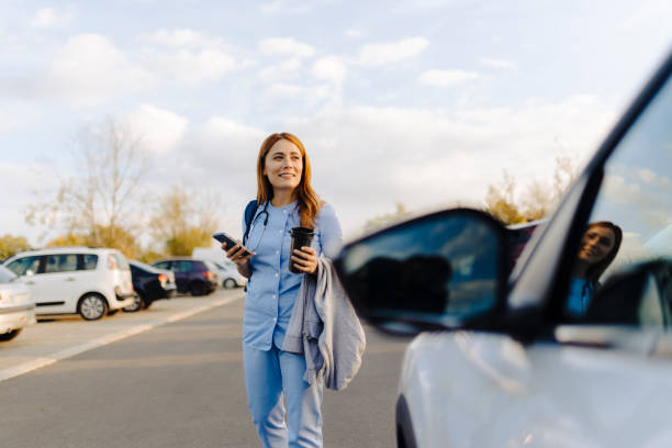 istock Cheerful female nurse uses smartphone while walking to work 2187188791