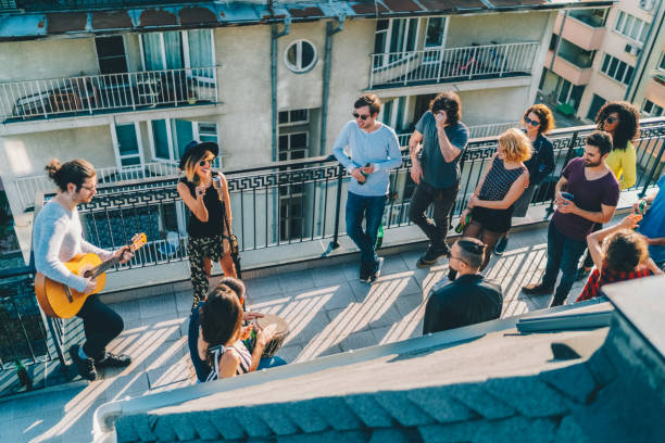 istock Friends drinking and partying on the rooftop 2187189543