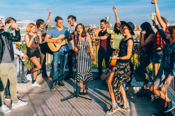 istock Friends drinking and partying on the rooftop 2187189574