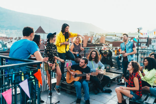 istock Friends drinking and partying on the rooftop 2187189870