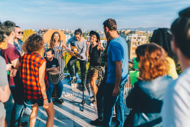 istock Friends drinking and partying on the rooftop 2187189955