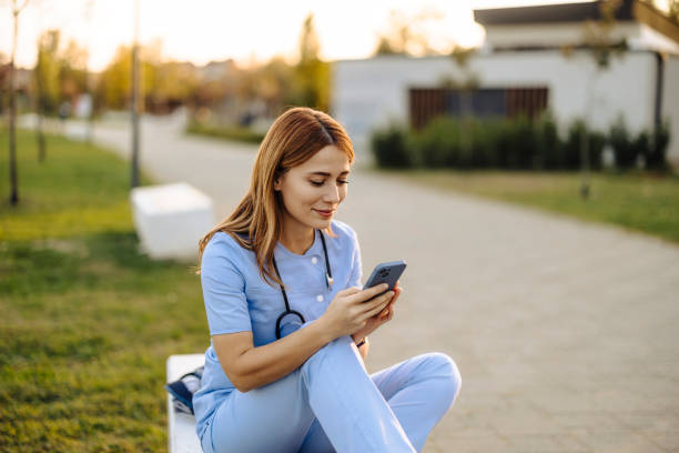 istock Nurse taking a break and using smart phone outdoors 2187190002
