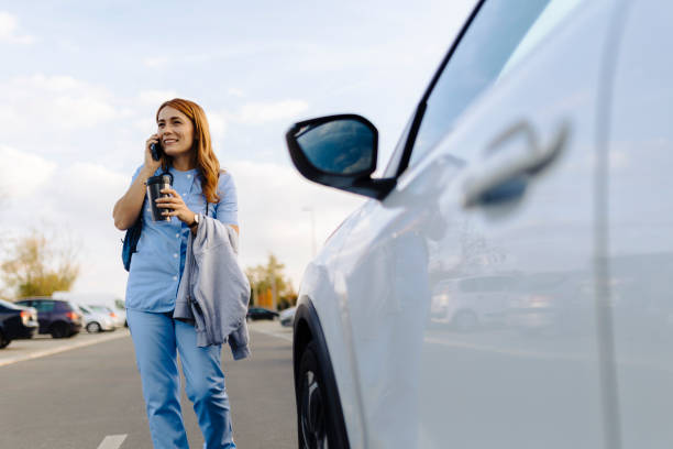 istock Cheerful female nurse uses smartphone while walking to work 2187190209