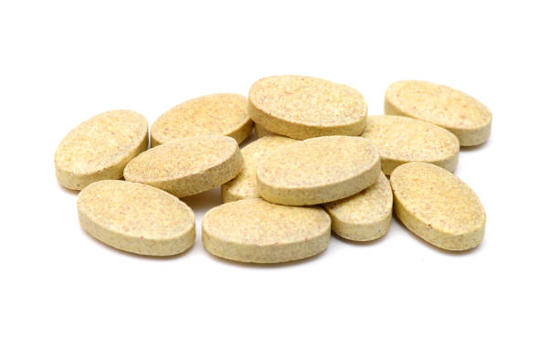 istock Brown pills, medicine isolated on white background, top view 2187190468