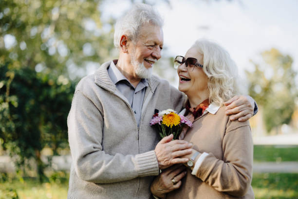 istock An elderly couple walking through the park in autumn 2187190514