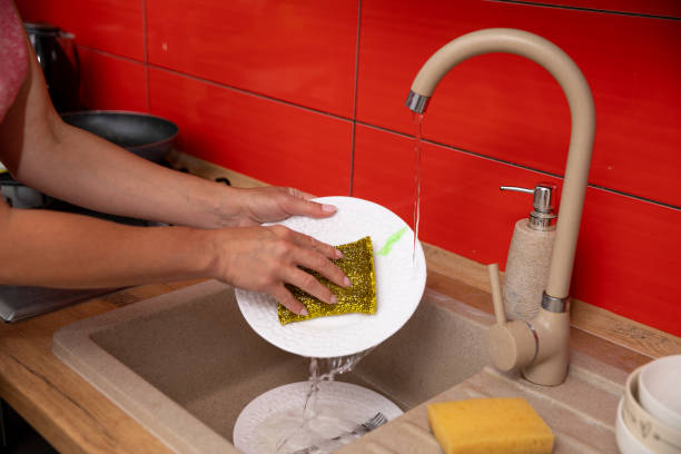 istock Washing Dishes in a Modern Kitchen that Features Attractive Red Accents Throughout 2187191426