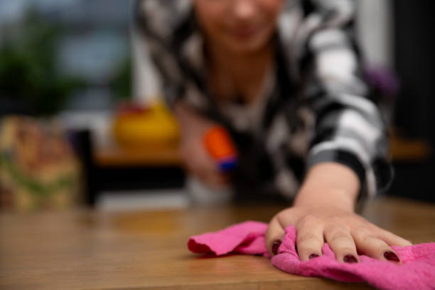 istock A person diligently cleaning a surface using a pink cloth in a modern interior setting 2187191735