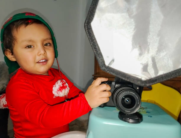 2 year old boy happy with his camera at Christmas, expressing love for Christmas memories
