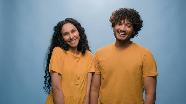 istock Blue studio background happy multiracial couple showing heart shape St Valentines Day romantic relationships love married man and woman sincere feelings followers kindness volunteering Ukraine support 2187193642