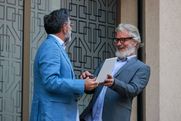 istock Two senior businessmen talking about job 2187193878