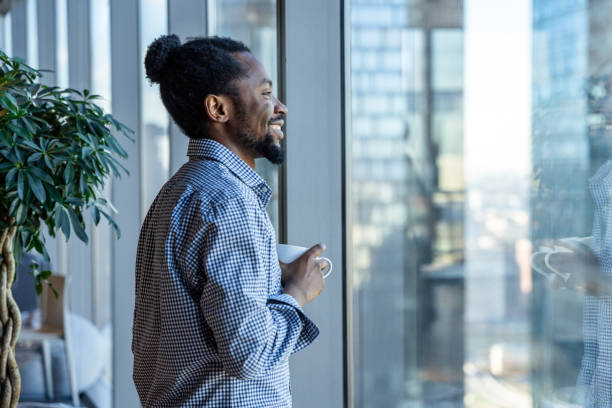 istock A Man Enjoying Coffee Break by Large Office Window 2187193966