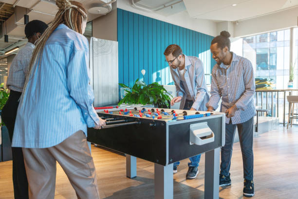 istock Young Professionals Engaging in a Fun Office Foosball Game 2187194051
