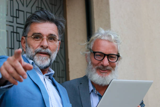 istock Two senior businessmen talking about job 2187196777