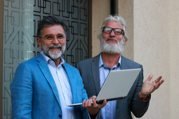 istock Two senior businessmen talking about job 2187196805