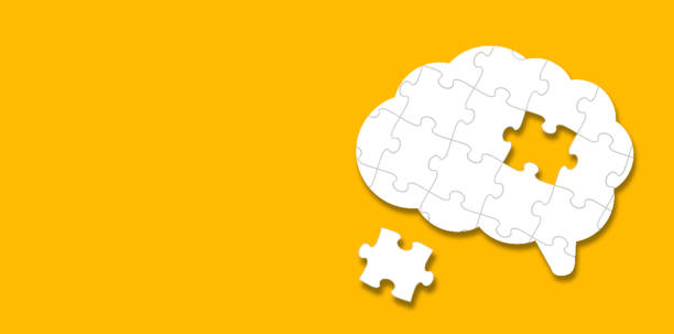 istock Brain shaped white jigsaw puzzle on yellow background 2187198244