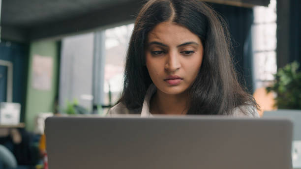 istock Indian anxious woman with computer working business problem in office Arabian dissatisfied girl worker upset confused businesswoman work with laptop online mistake trouble bad results job difficulties 2187198832
