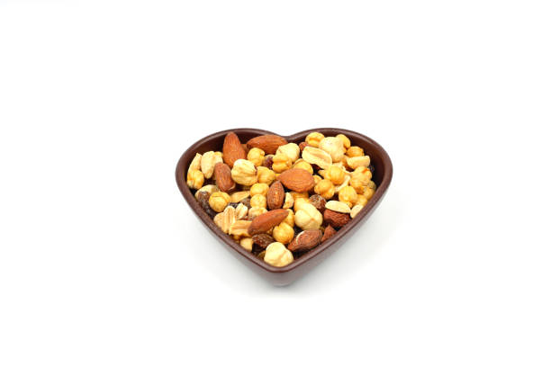 istock mixed nuts in bowl. Mix of various nuts on white background. 2187199146