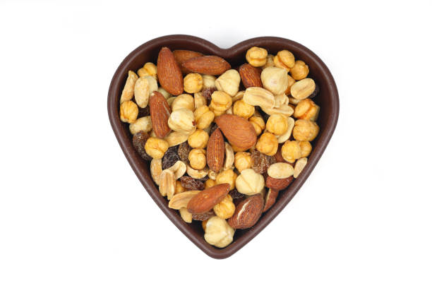 istock mixed nuts in bowl. Mix of various nuts on white background. 2187199232