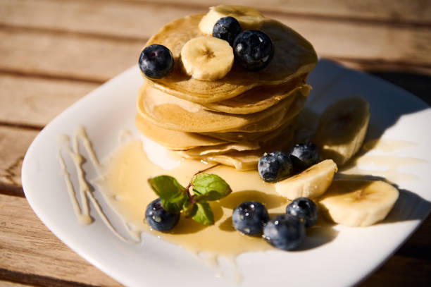 Delicious pancake stack with bananas and blueberries