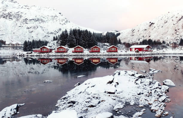 istock Captivating and Charming Red Cabins Resting by a Beautiful Snowy Lake at Dawn Light 2187203471