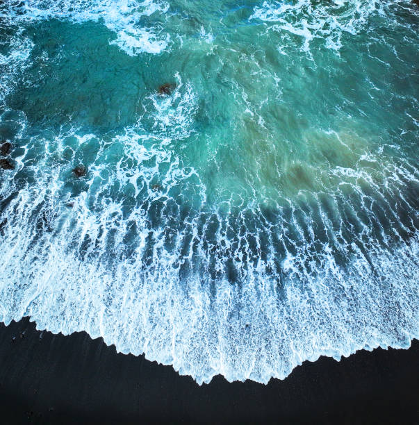 istock Atlantic ocean from above, waves and black basalt sand and rocks, view from a drone. 2187204667