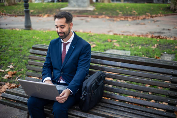 istock copyspace businessman sitting on a park bench working on his laptop 2187205453