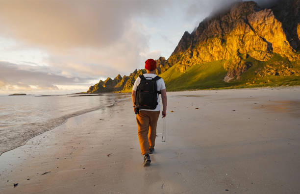 istock A Hiker Enjoying a Tranquil Stroll on a Beautiful, Serene Beach During a Stunning Sunset 2187205607