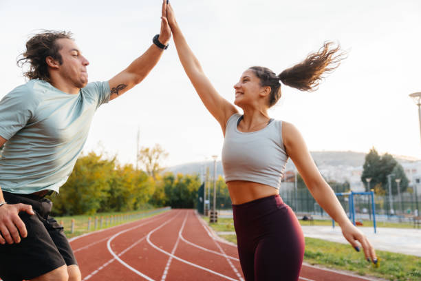 istock Young man and young woman greeting with high five after succesful training 2187205978