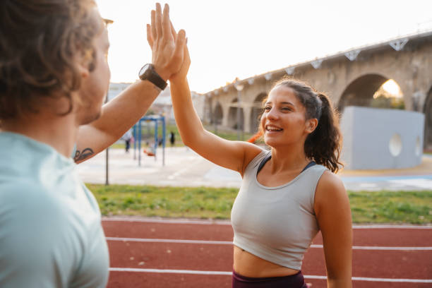 istock Young man and young woman greeting with high five after succesful training 2187206000