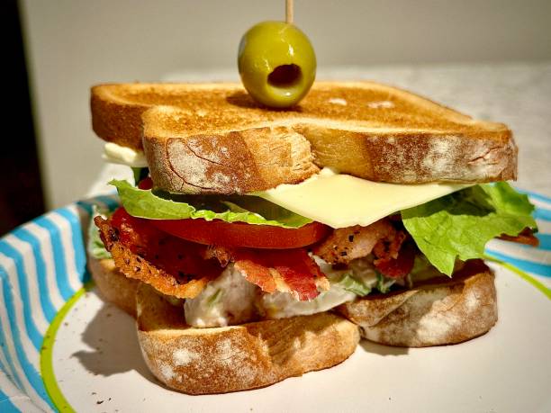 Big chicken salad club sandwich with bacon, lettuce, tomato and American cheese.