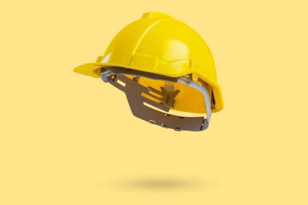 istock Safety construction helmet on yellow background 2187215099