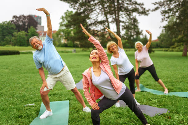 istock Outdoor Yoga Class for Seniors with Diverse Instructor 2187215497