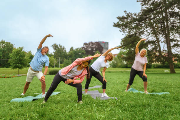 istock Senior Group Outdoor Yoga Session with Instructor 2187215513