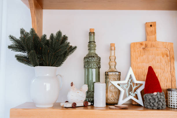 istock Rustic holiday decor featuring greenery and vintage glass bottles on shelf 2187215865