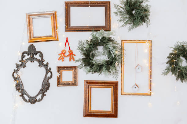 istock Decorative holiday wall with empty frames, wreaths, and fairy lights 2187215876