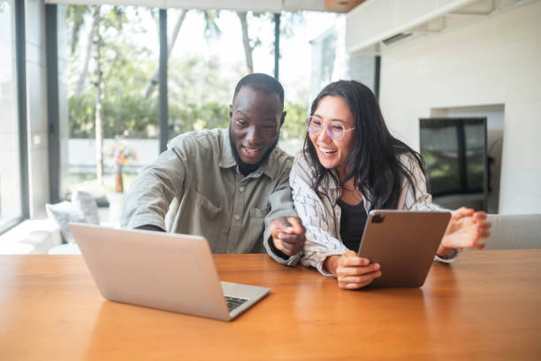 istock Cheerful Black Man and Asian Woman Engaging with Technology 2187217269