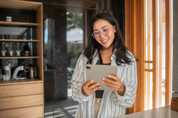 istock Asian Woman Enjoying Technology Indoors 2187217279