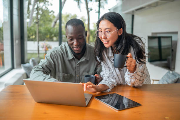 Asian Woman and Black Man Team Up for Remote Work