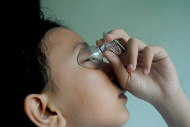 A close up view of a senior woman applying eye drops
