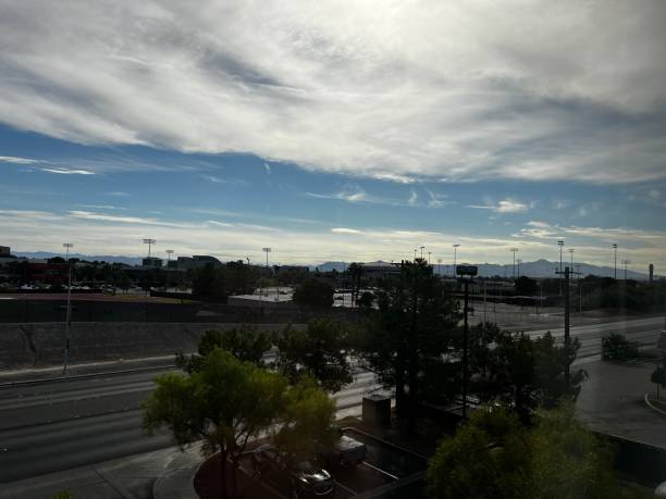 A serene view of an urban landscape featuring mountains in the background under a clear sky