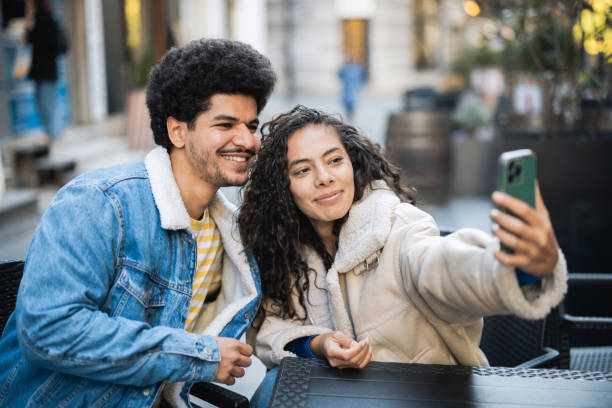 istock Arab couple taking a selfie at the cafe 2187223574