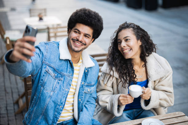 istock Happy Middle Eastern couple taking a selfie while enjoying at the cafeteria 2187223602