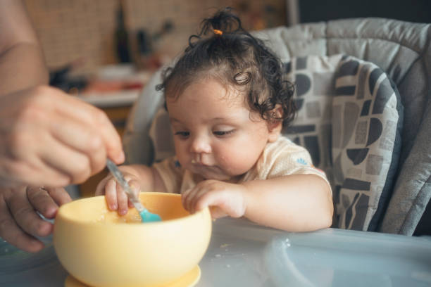 istock Curious Baby Exploring Food During Mealtime 2187229060